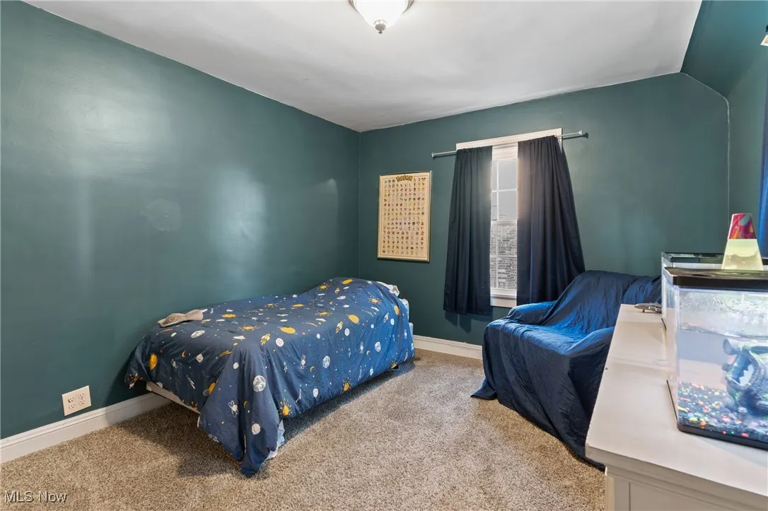 Carpeted bedroom featuring baseboards
