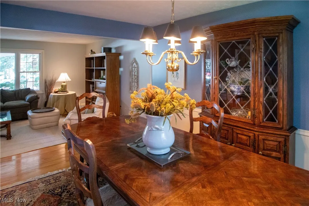 Dining area with a chandelier and wood finished floors