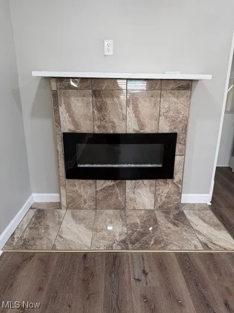 Detailed view of a fireplace and wood finished floors