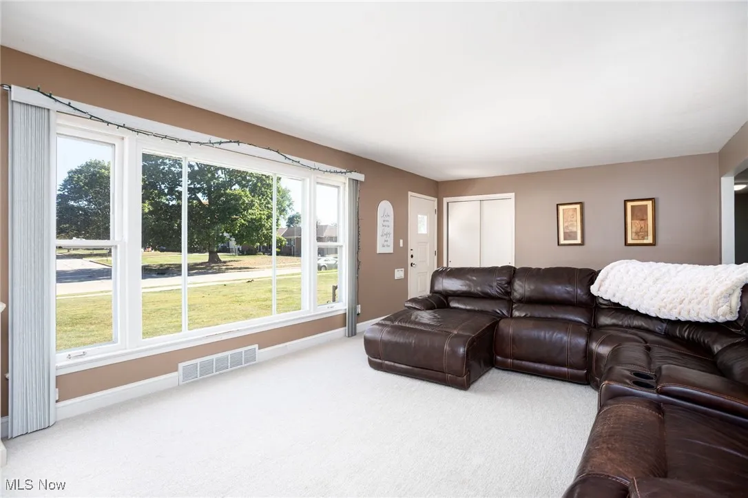 Living room featuring carpet and baseboards