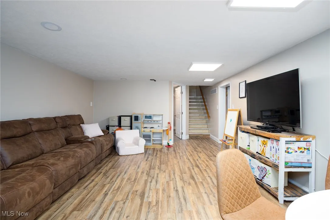 Living area with stairs and light wood-type flooring