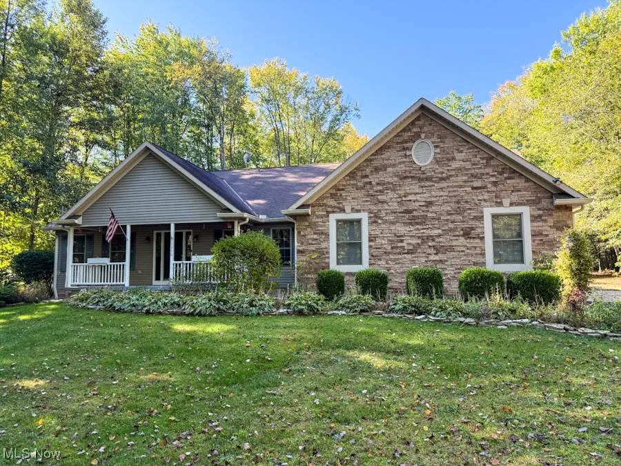 Ranch-style house with a front yard and a porch