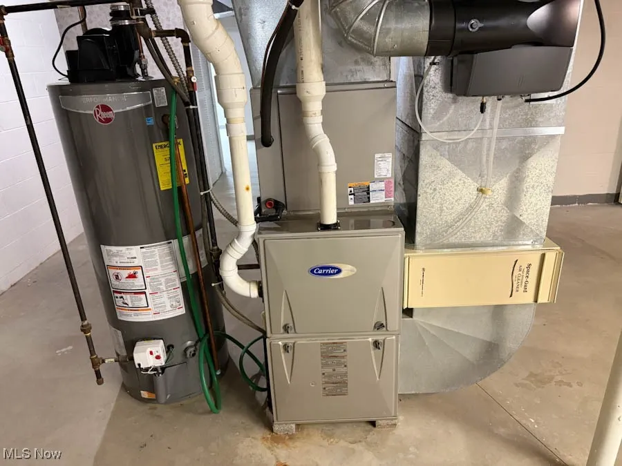Utility room with gas water heater and heating unit
