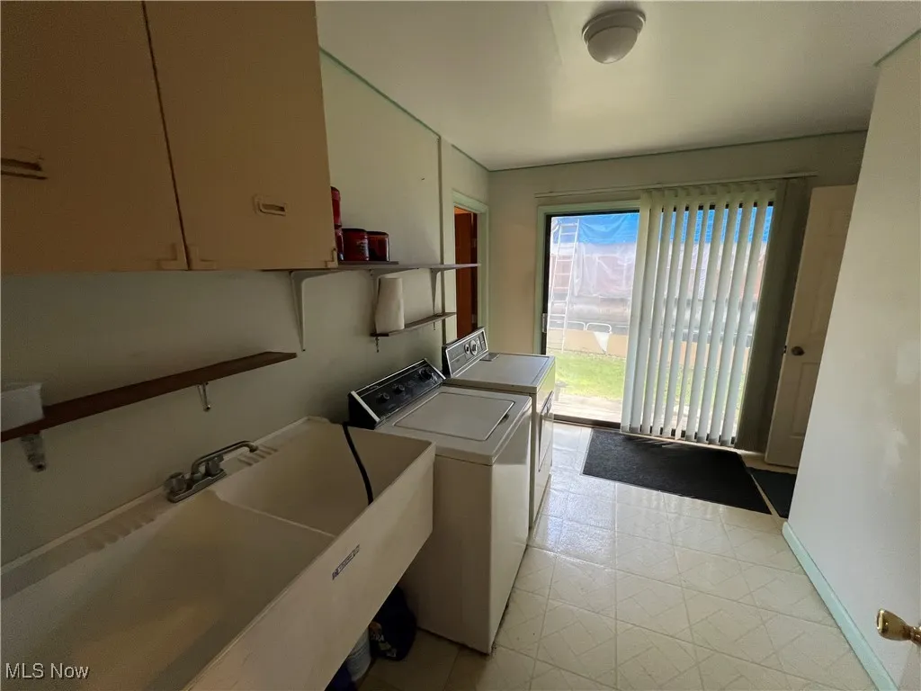 Laundry area with a sink and washer and dryer