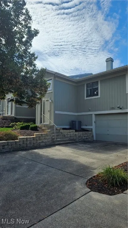View of front facade with driveway and an attached garage