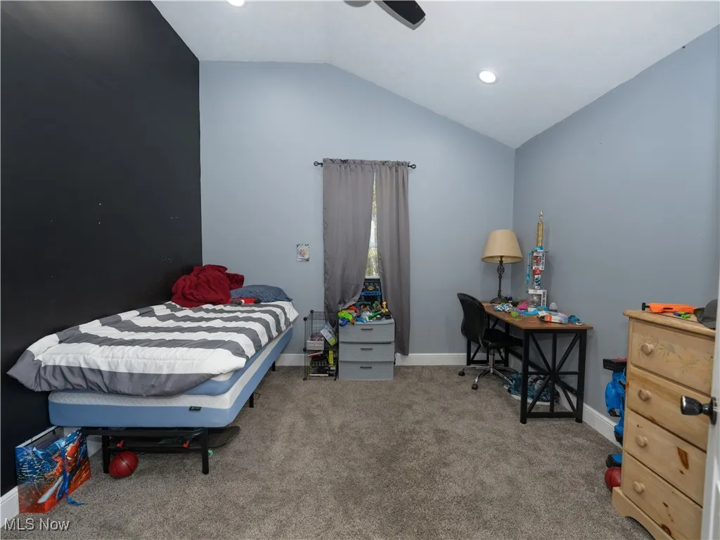 Bedroom with lofted ceiling, light carpet, a ceiling fan, and recessed lighting