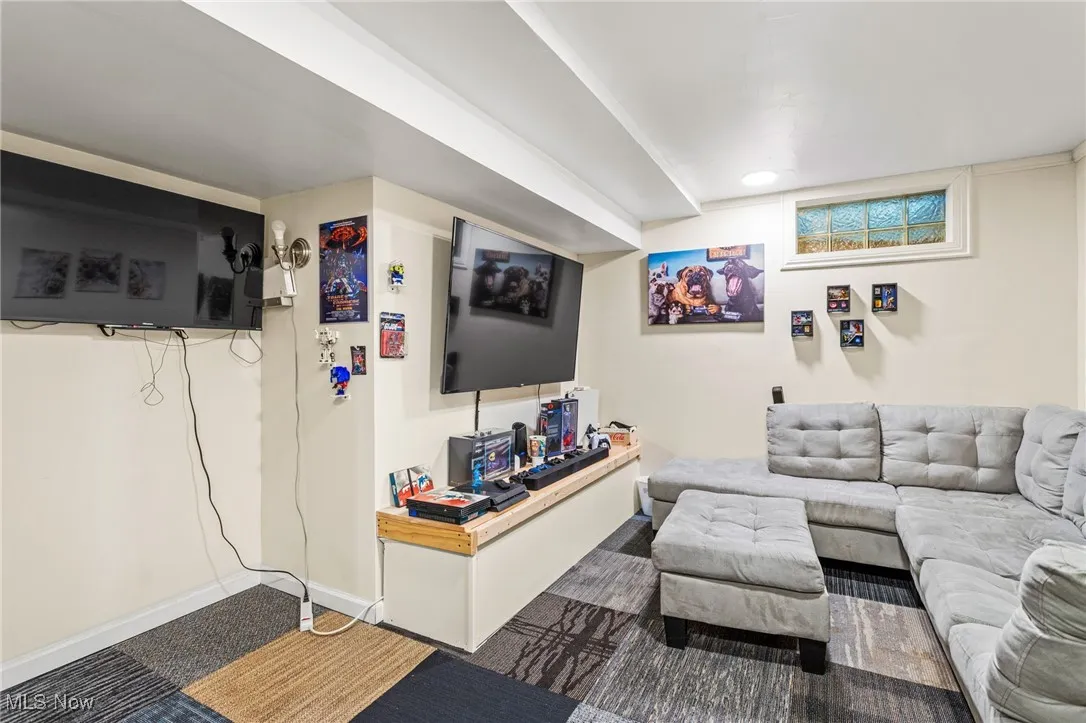 Living area featuring carpet flooring and baseboards