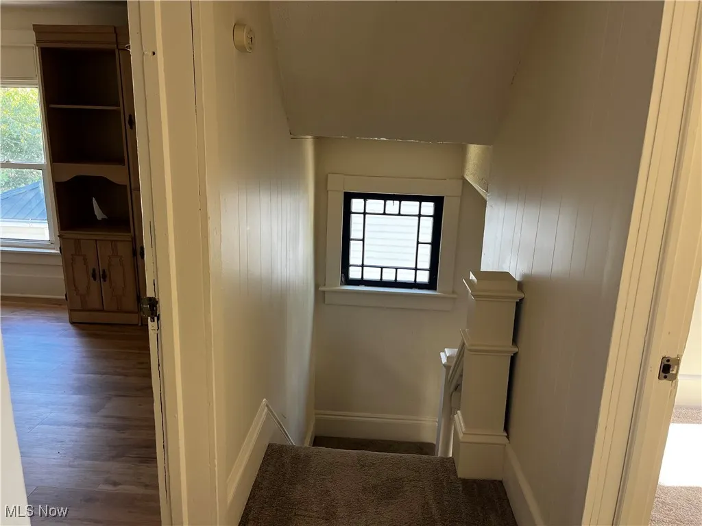 Stairs featuring wood finished floors and baseboards