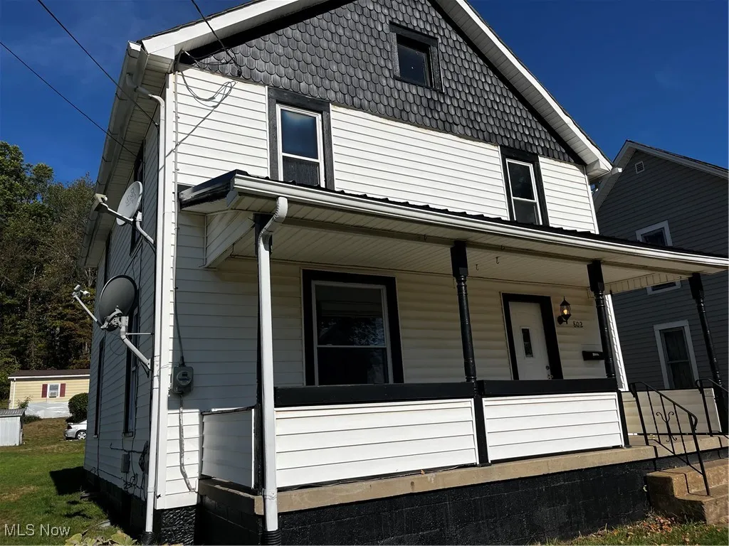 View of side of home featuring a porch