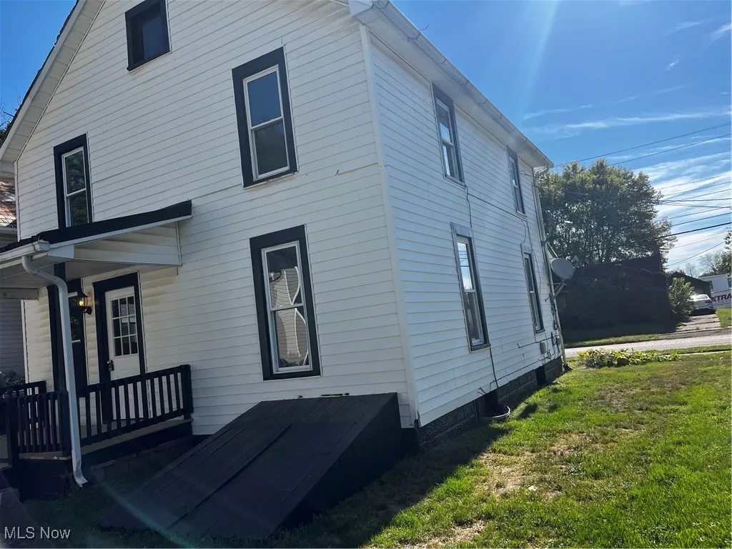 View of home's exterior featuring a yard and a deck