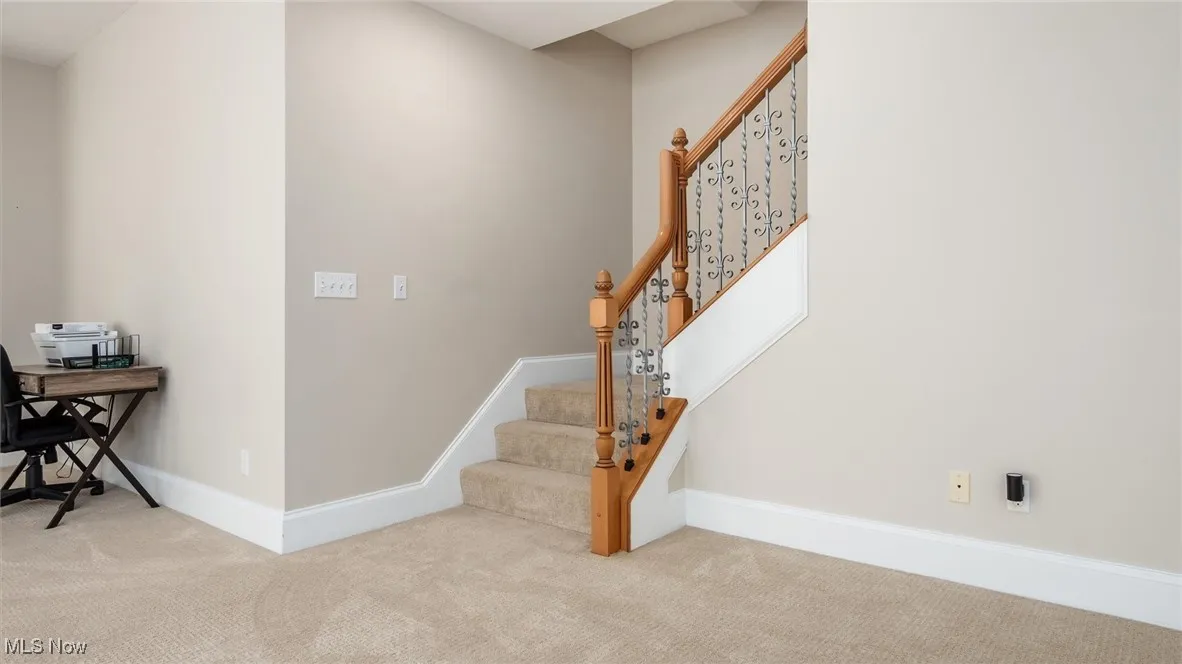 Stairway with baseboards and carpet flooring