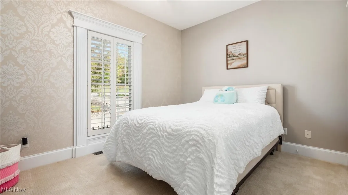 Carpeted bedroom with baseboards