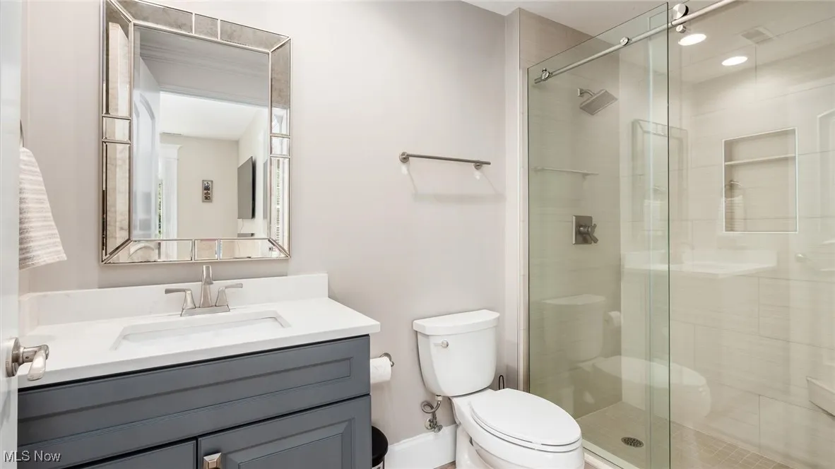 Bathroom with vanity and a shower stall