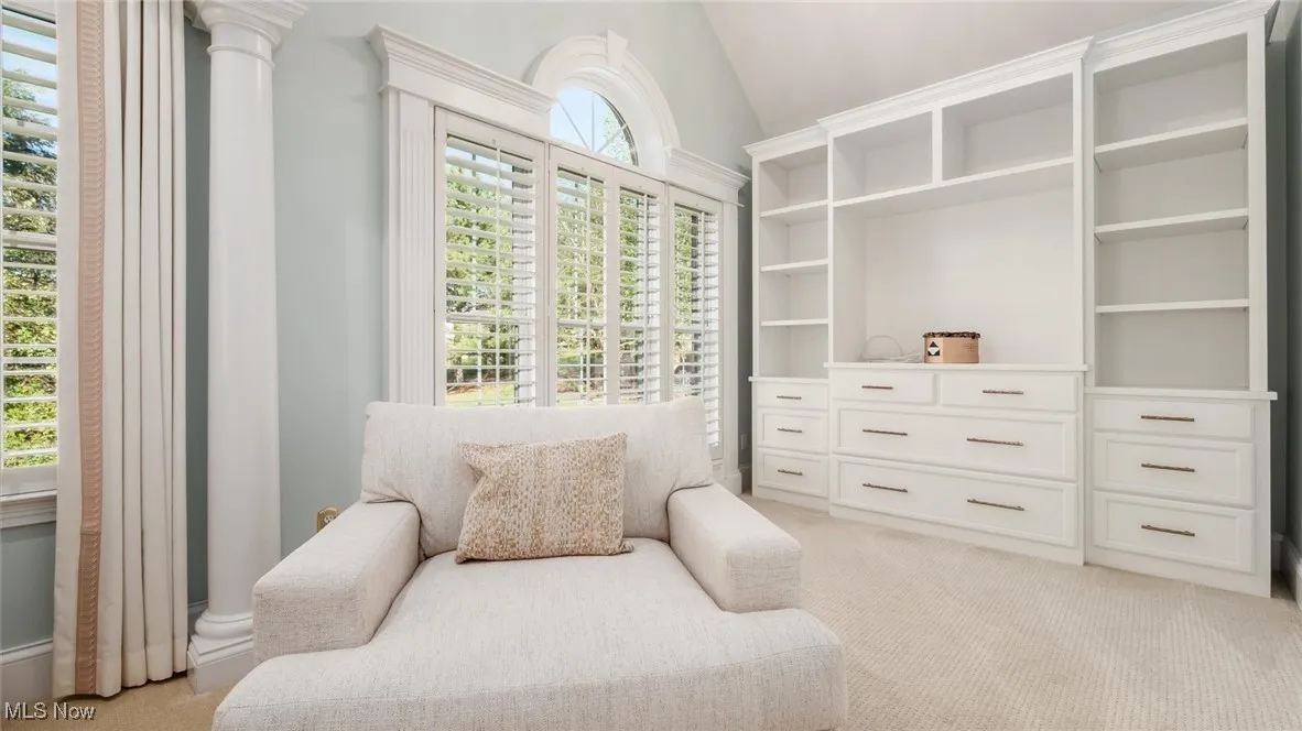 Bedroom area featuring light carpet and vaulted ceiling