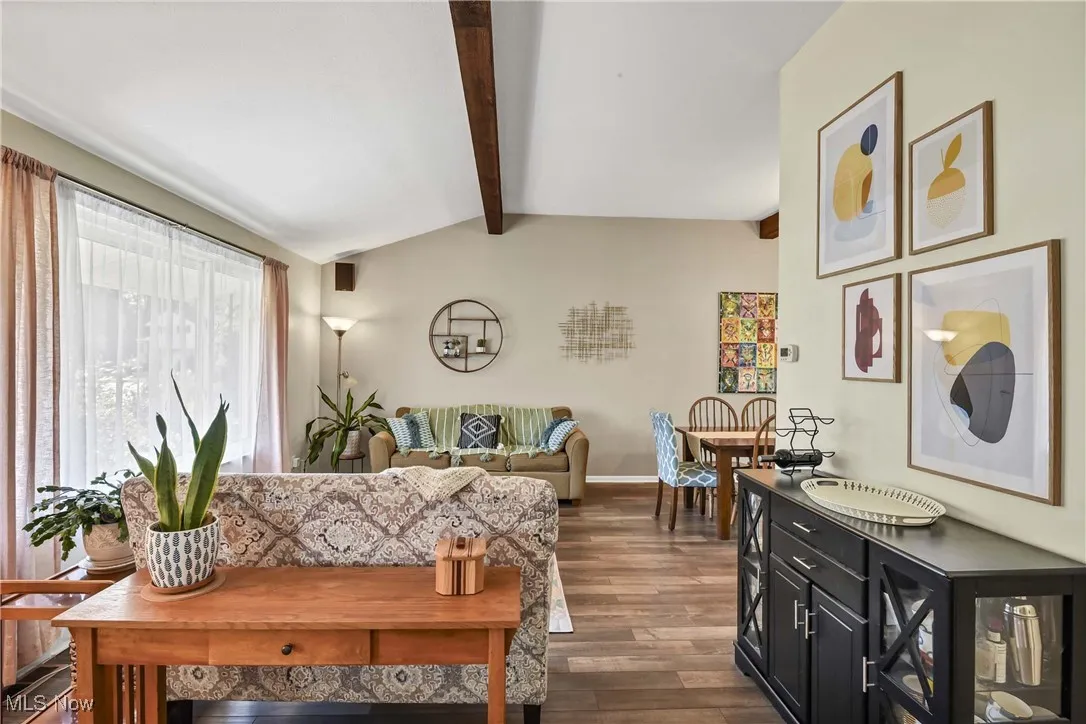 Dining area with dark wood-type flooring and a chandelier