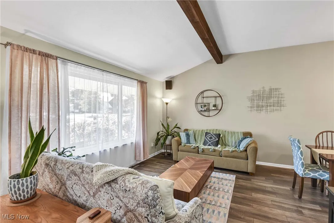 Living room with dark wood finished floors and baseboards
