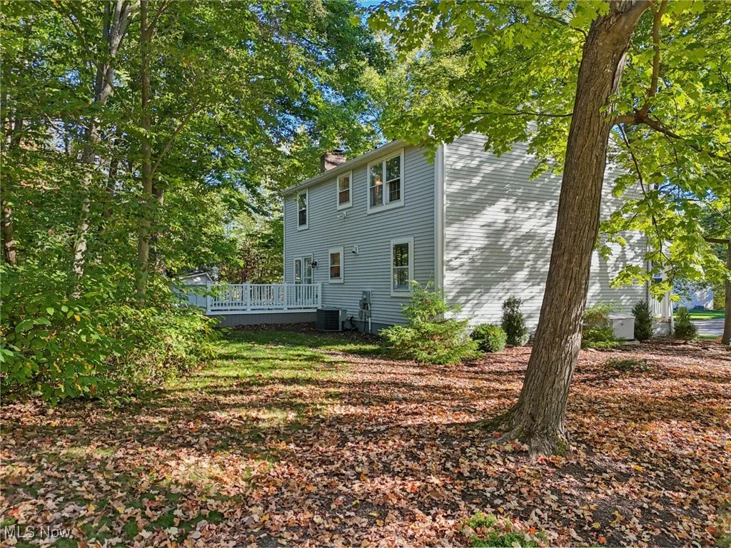 Rear view of house with a chimney and a wooden deck
