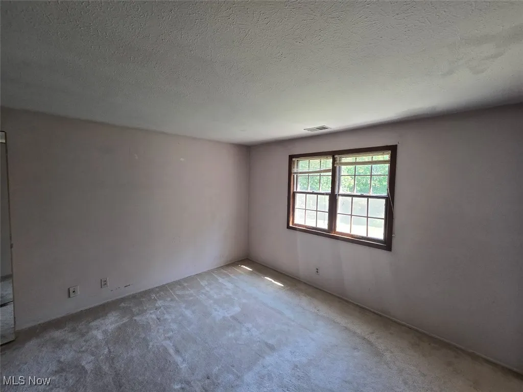 Bedroom featuring carpet flooring and a textured ceiling