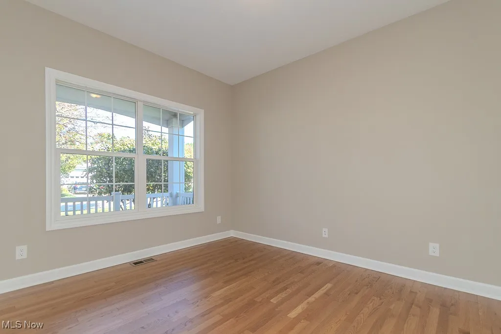 Unfurnished room featuring baseboards and light wood-style floors