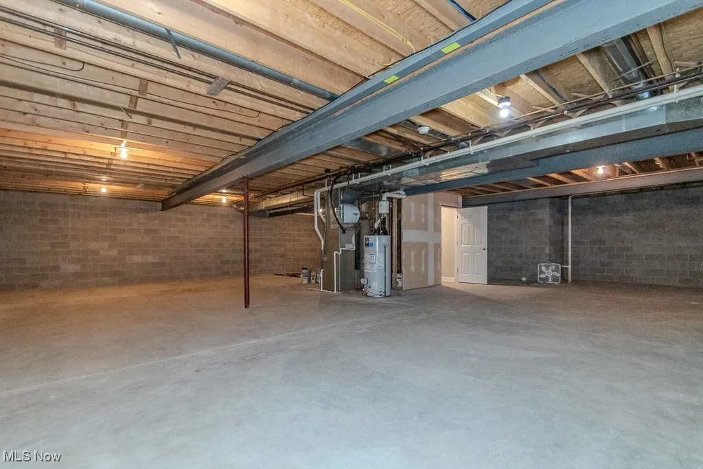 Unfinished basement with gas water heater and heating unit