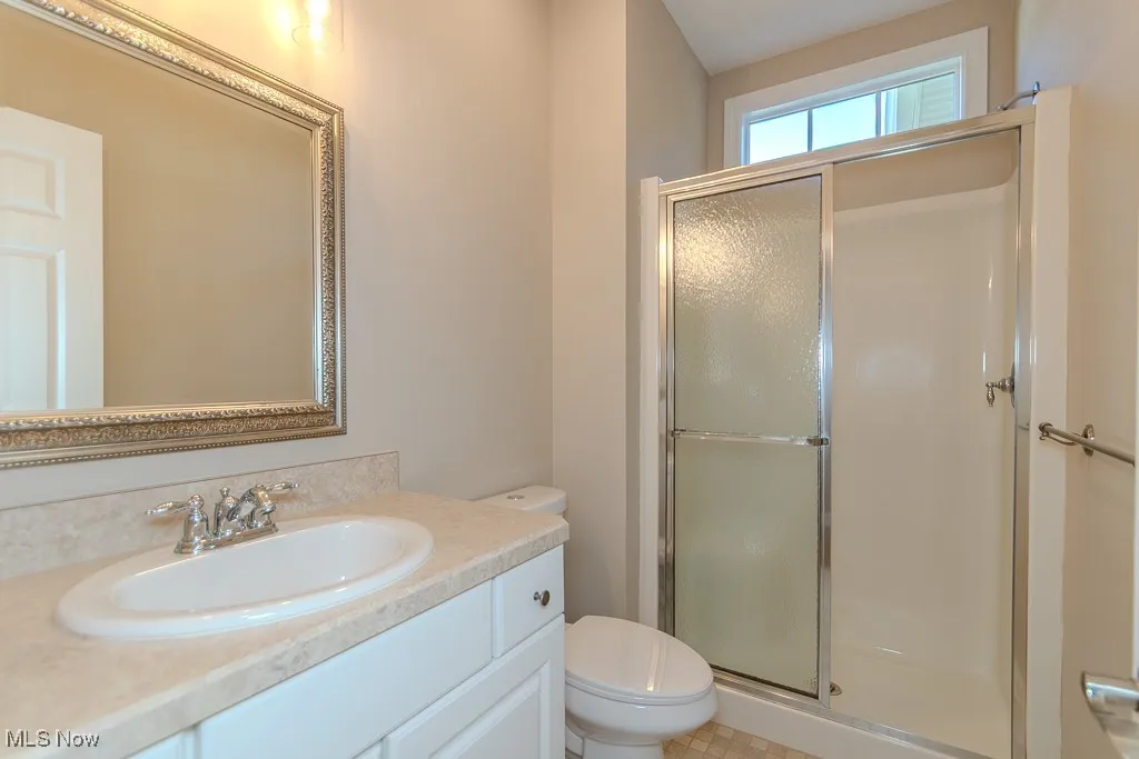 Bathroom featuring a stall shower and vanity