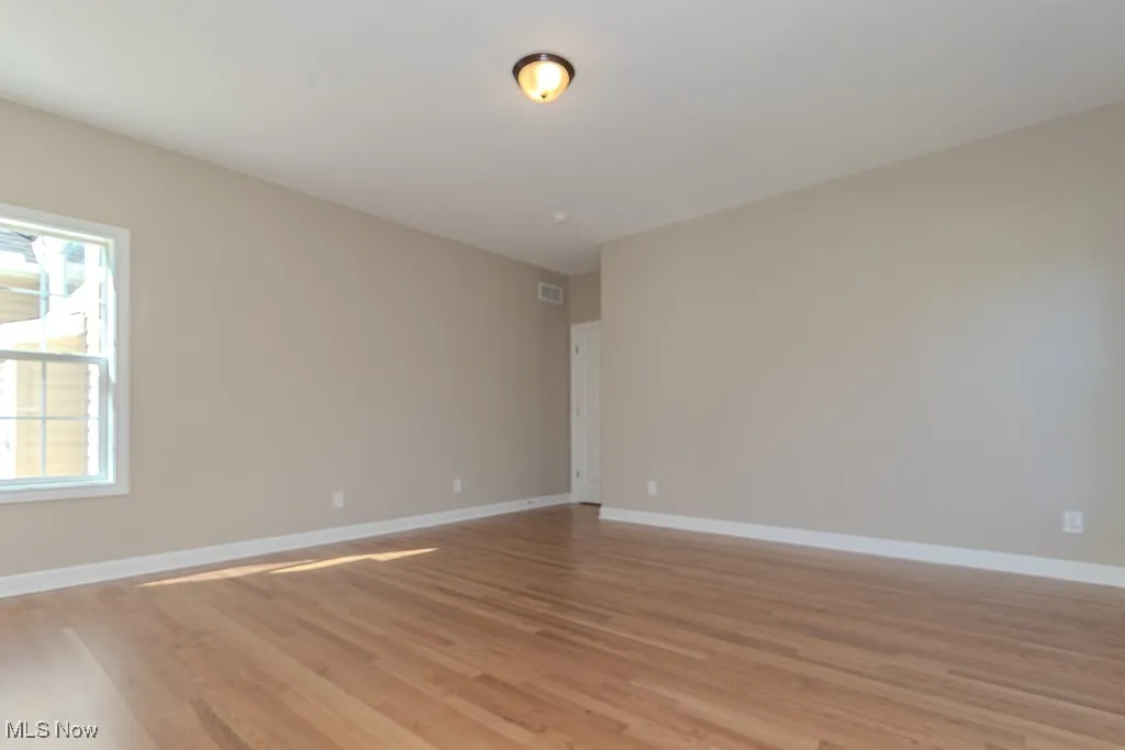 Empty room featuring light wood-style floors and baseboards