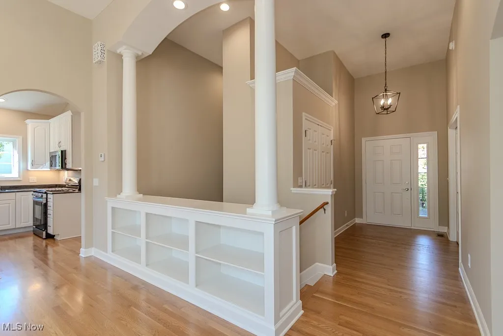 Foyer entrance featuring light wood finished floors and a towering ceiling