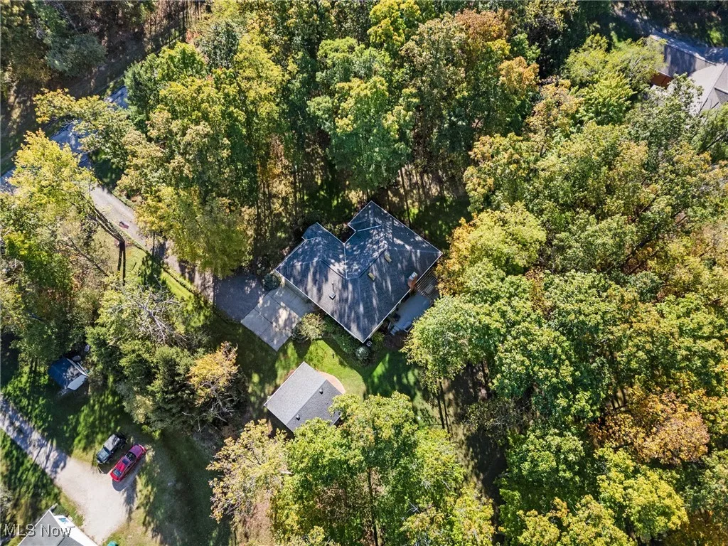 View of subject property featuring a heavily wooded area