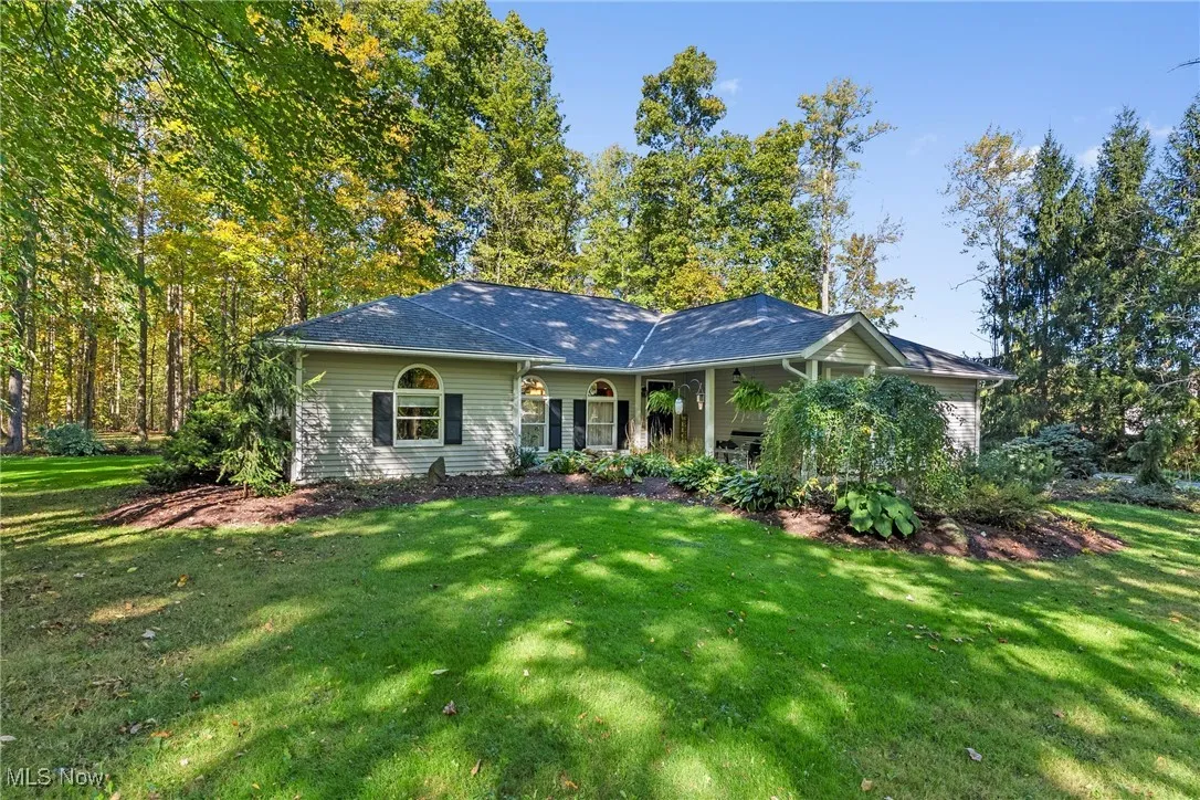 Ranch-style home featuring a front lawn