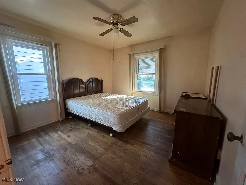 Bedroom featuring dark wood-style floors and ceiling fan