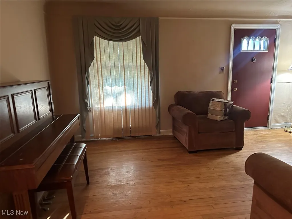 Living room with light wood-type flooring and baseboards