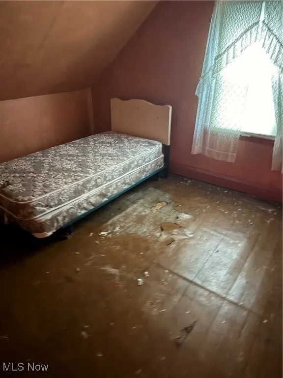 Bedroom with lofted ceiling