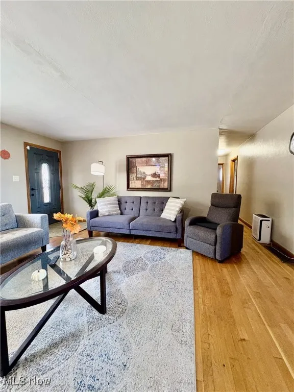 Living area with wood-type flooring and baseboards