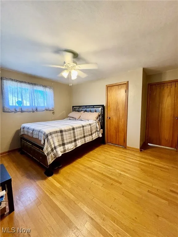 Bedroom featuring light wood-style floors and a ceiling fan