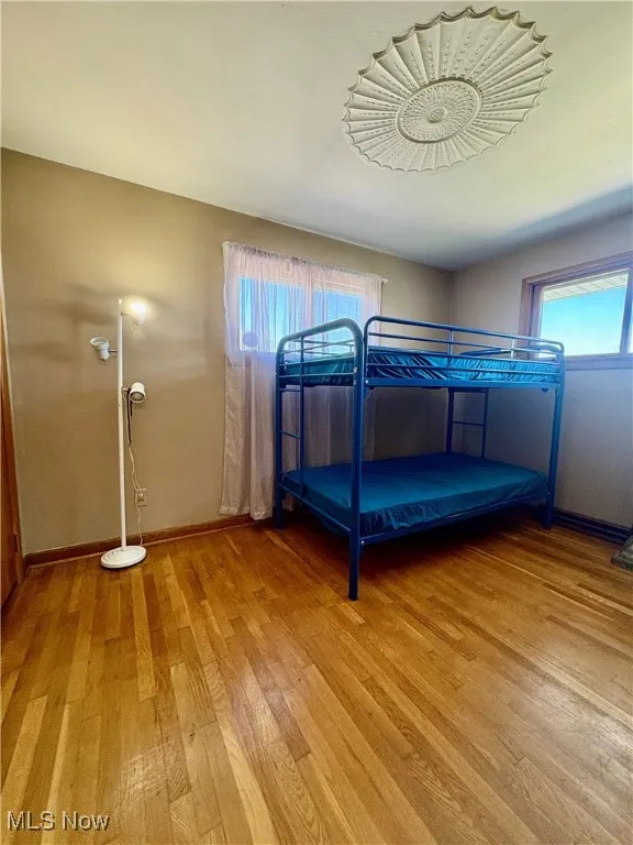 Unfurnished bedroom featuring baseboards and light wood-style flooring
