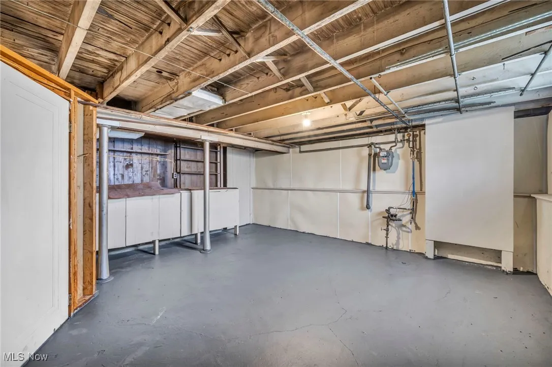 Unfinished below grade area featuring gas meter