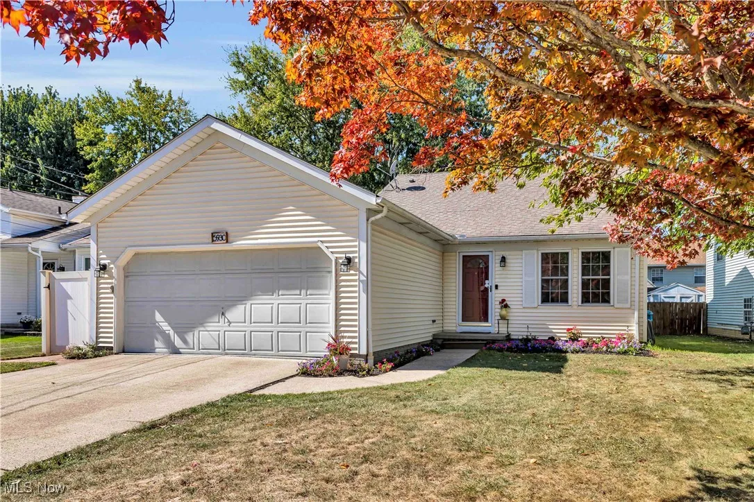 Vinyl sided split level home with a 2 car attached garage, concrete driveway and fresh landscaping. Beautiful Japanese Maple Tree in the front yard as well.