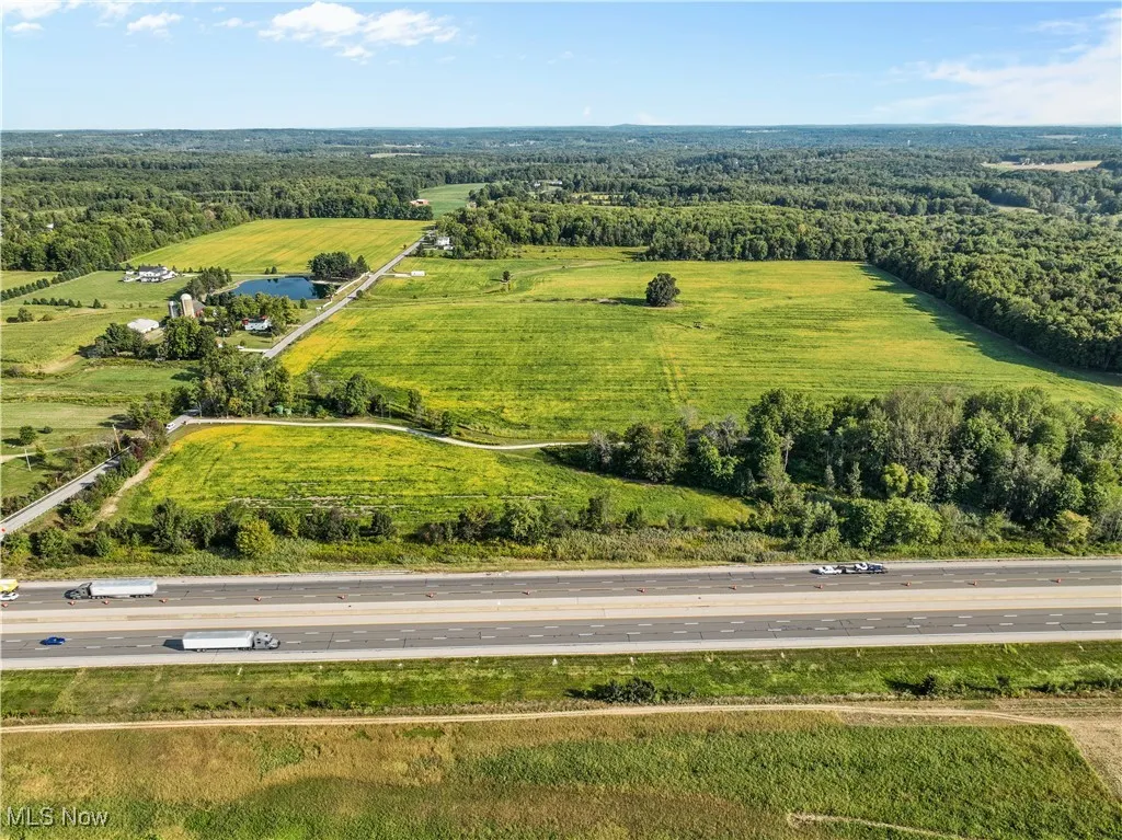 Aerial view of sparsely populated area with a heavily wooded area
