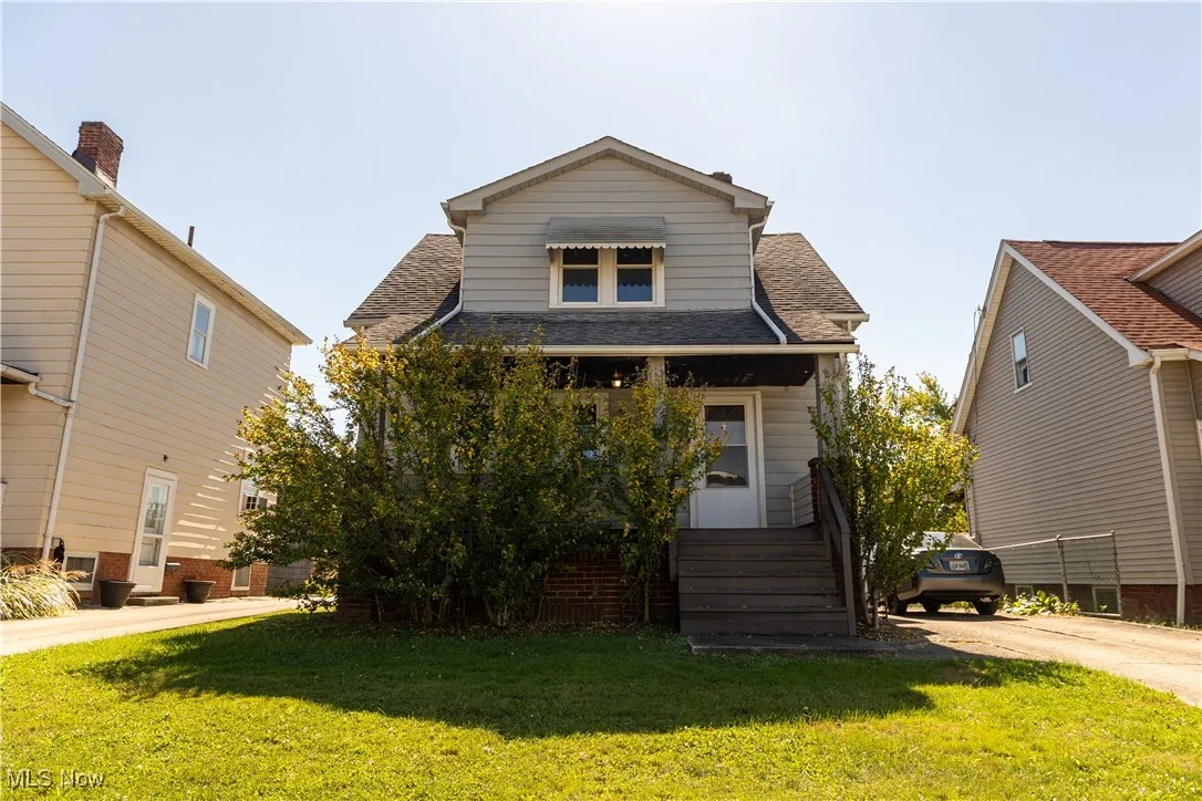 Exterior view of home showcasing large porch and front yard