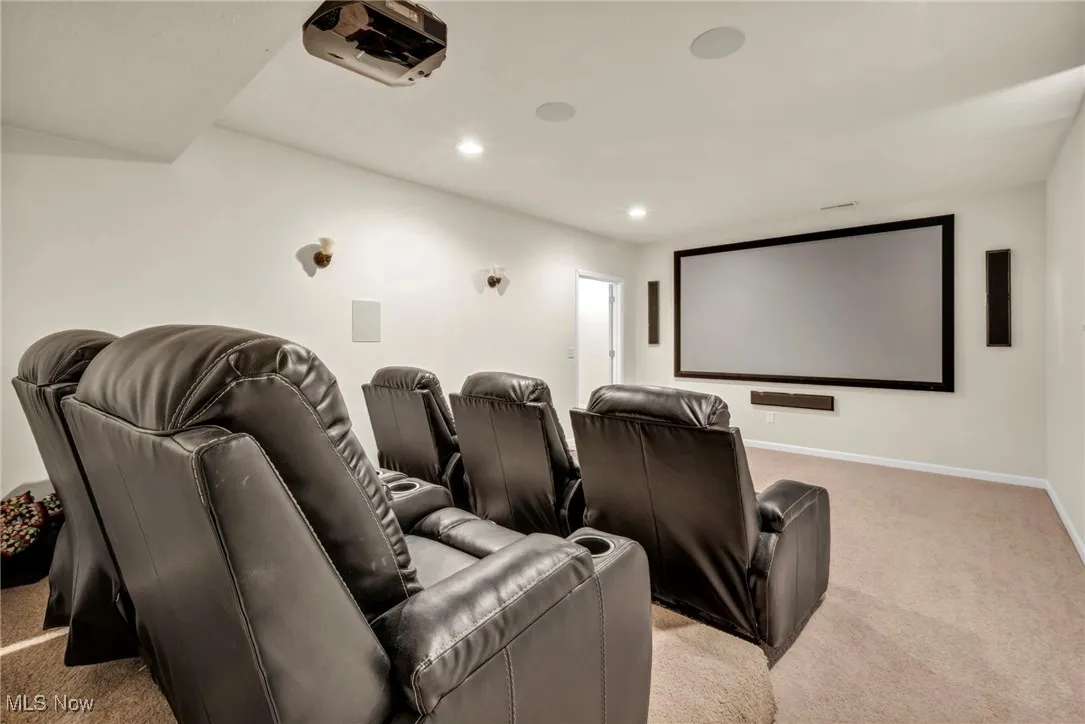 Home theater room featuring light colored carpet and recessed lighting