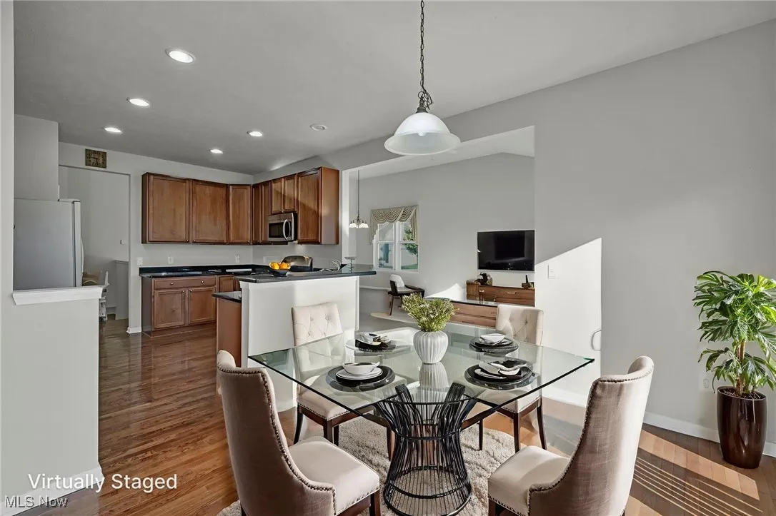 Dining room with recessed lighting and dark wood-style flooring