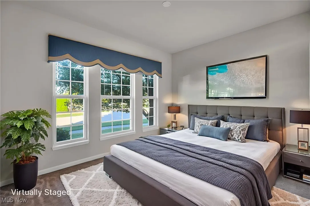 Carpeted bedroom featuring baseboards