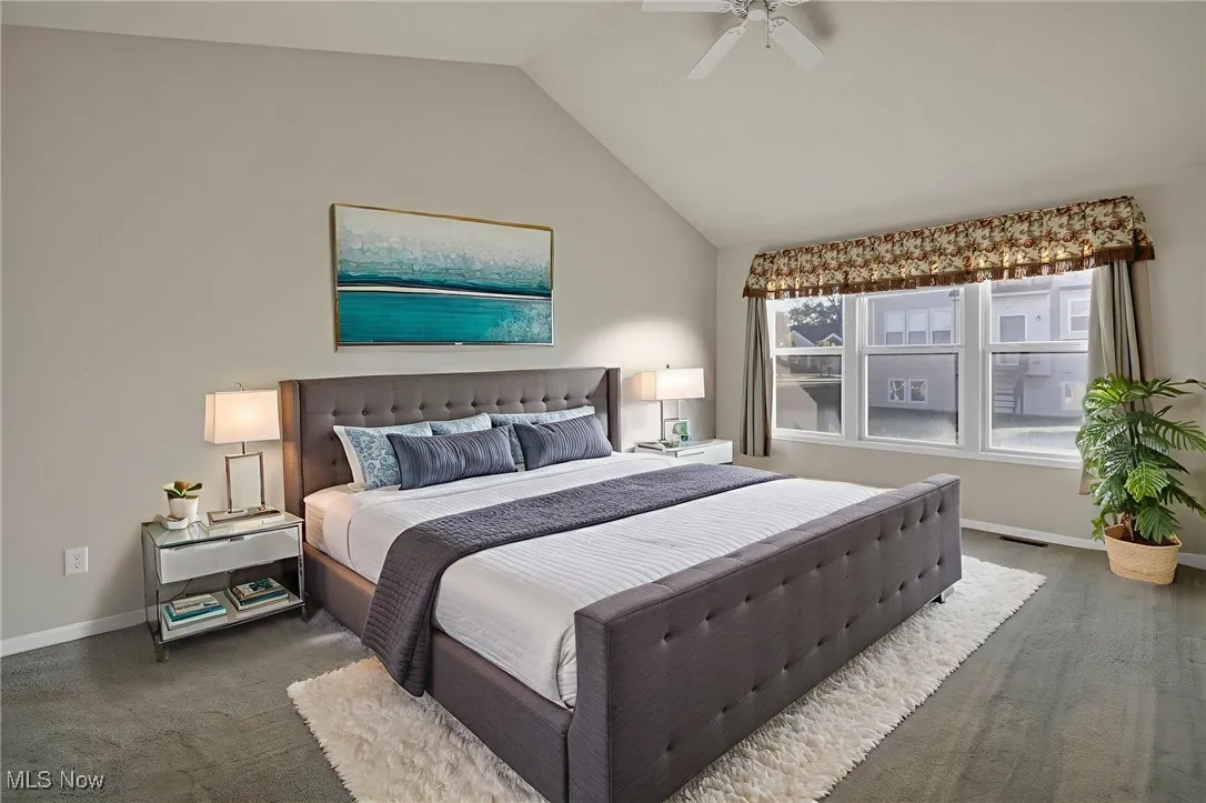 Bedroom featuring vaulted ceiling and ceiling fan