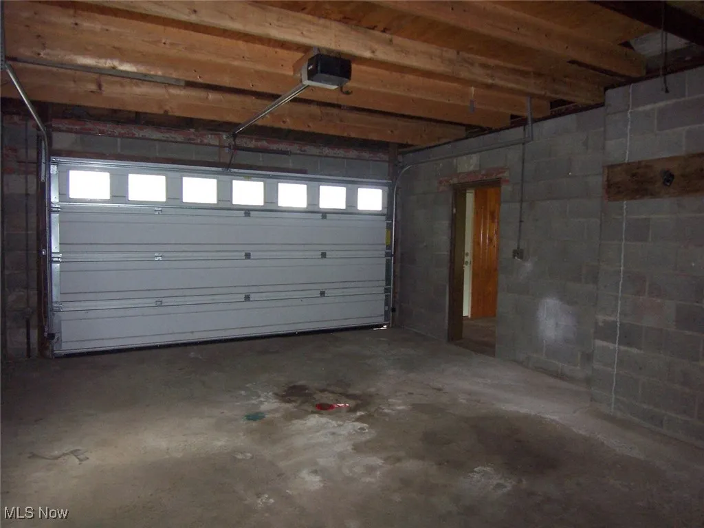 Garage with concrete block wall and a garage door opener