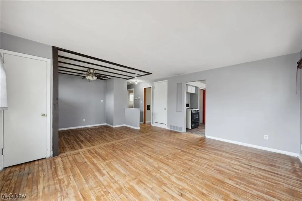 Empty room featuring light wood-type flooring and ceiling fan