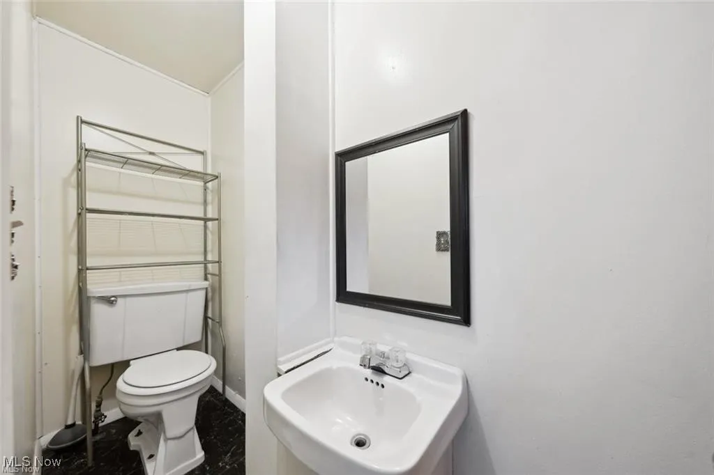 Upstairs Half bath with a sink and toilet