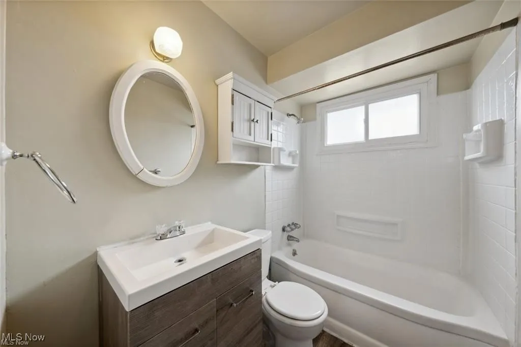 Main level Bathroom featuring shower / bath combination and vanity