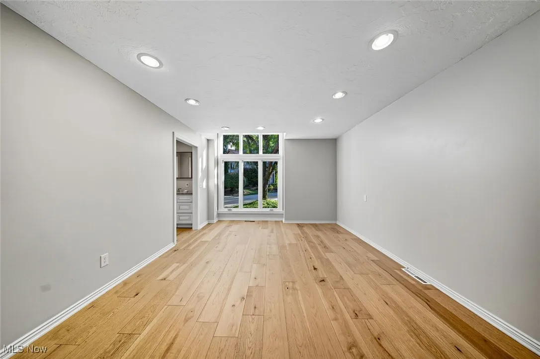 Unfurnished room featuring recessed lighting, light wood-style floors, and a textured ceiling