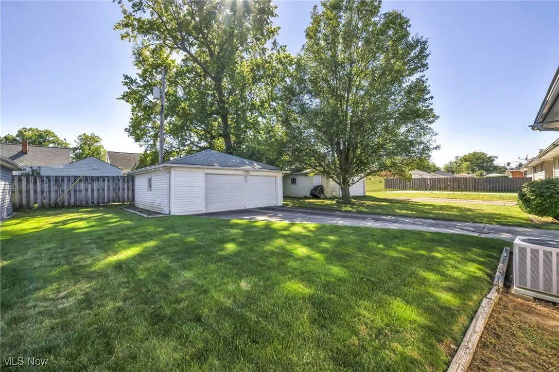 View of yard with a detached garage and an outdoor structure