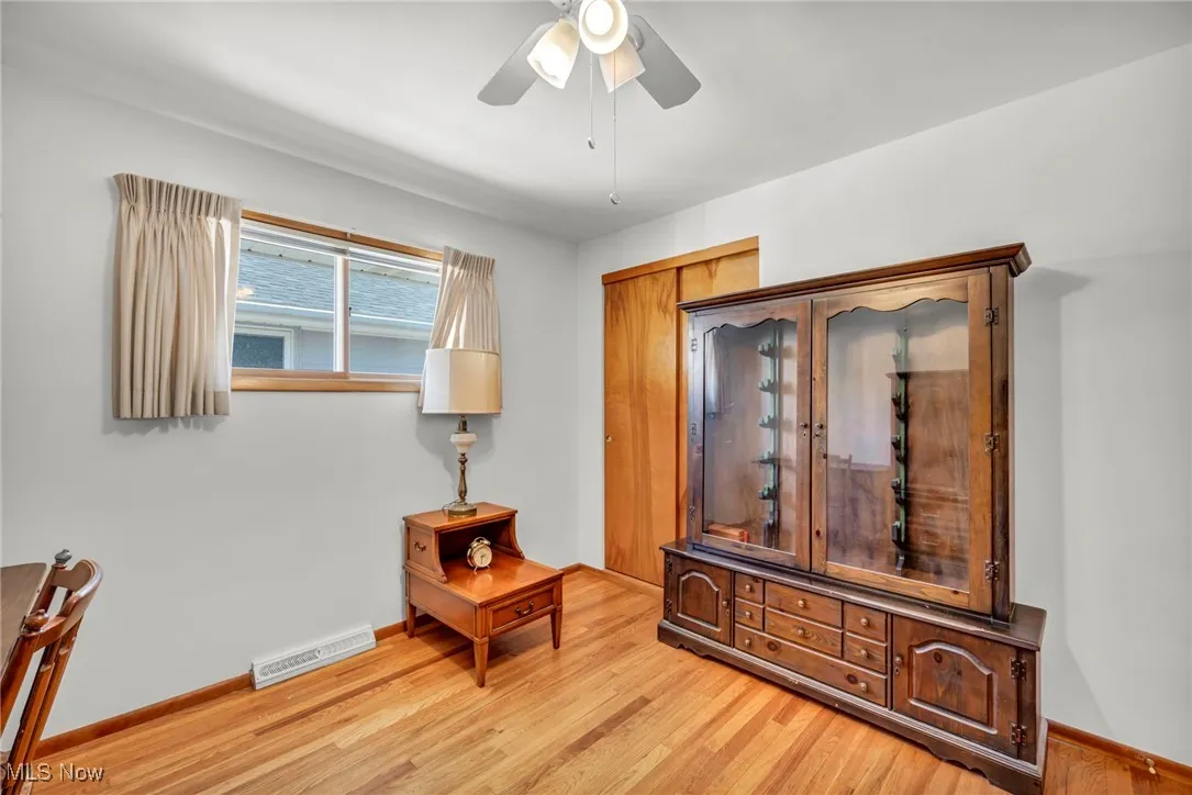 Living area featuring light wood-style floors and ceiling fan